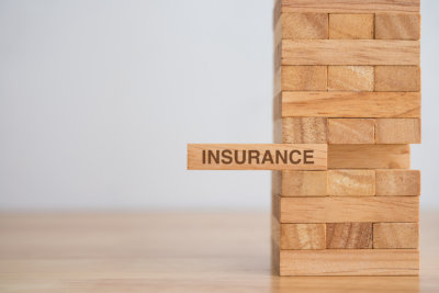 Wooden block tower with the word insurance
