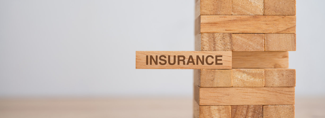 Wooden block tower with the word insurance